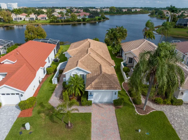 an aerial view of a house with outdoor space and lake view