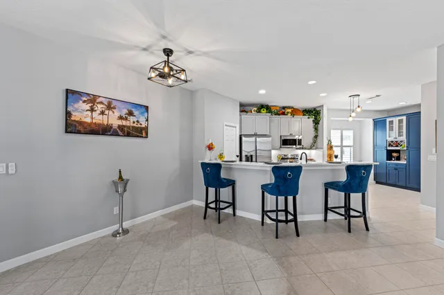 a living room with furniture a dining table and a window