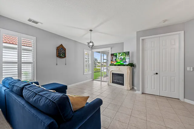 a living room with furniture and a fireplace with window
