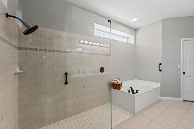 a bathroom with a bathtub and a shower