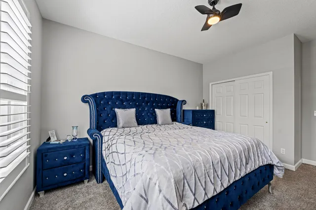 a bedroom with a bed and window