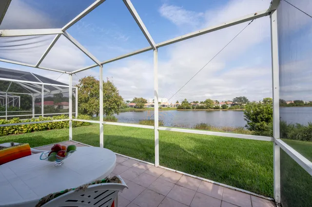 a view of backyard with outdoor seating and barbeque oven