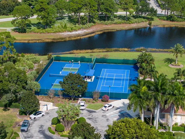 an aerial view of residential houses with outdoor space and swimming pool