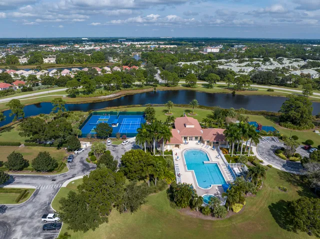 an aerial view of residential houses with outdoor space and swimming pool