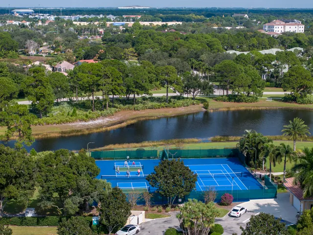an aerial view of lake residential houses with outdoor space and swimming pool
