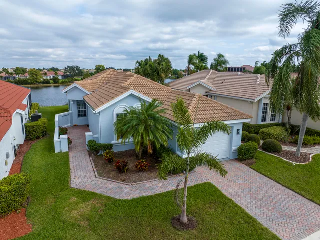 an aerial view of residential houses with outdoor space and trees