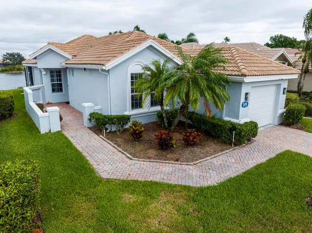 a view of a house with a yard patio and fire pit