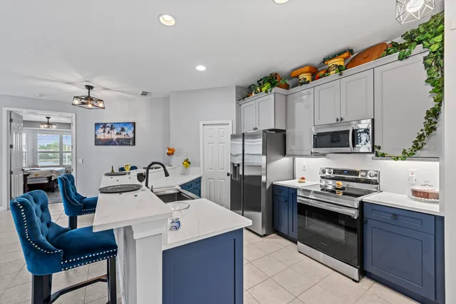 a kitchen with stainless steel appliances a stove sink microwave and cabinets