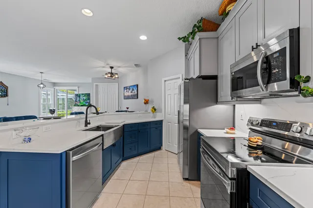 a kitchen with a sink appliances and cabinets