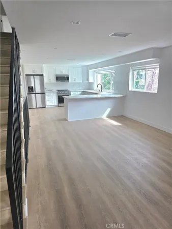 a view of kitchen with cabinets and wooden floor