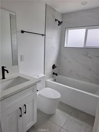 a bathroom with a sink a toilet and a bathtub