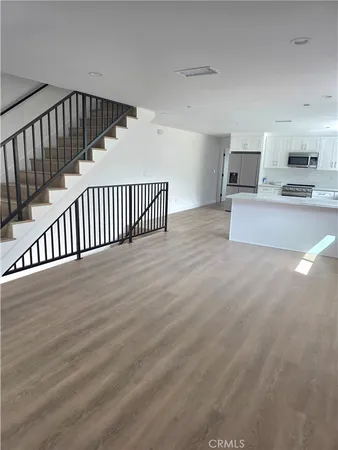 a view of a hallway with a livingroom and entryway