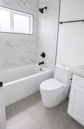 a bathroom with a toilet and a bathtub