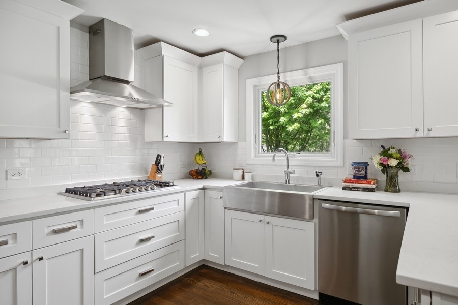3900 Rugen Road Glenview, IL 60025 - Photo 16 of 44 a kitchen with white cabinets sink and window