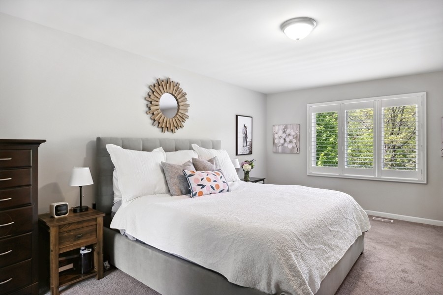 3900 Rugen Road Glenview, IL 60025 - Photo 19 of 44 a large bed sitting in a bedroom next to a window