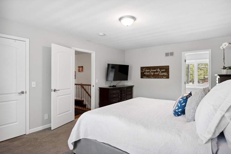 3900 Rugen Road Glenview, IL 60025 - Photo 20 of 44 a bedroom with a large bed and a tv