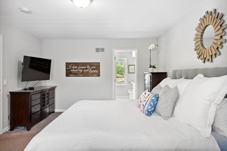 3900 Rugen Road Glenview, IL 60025 - Photo 21 of 44 a bedroom with a bed and a flat screen tv