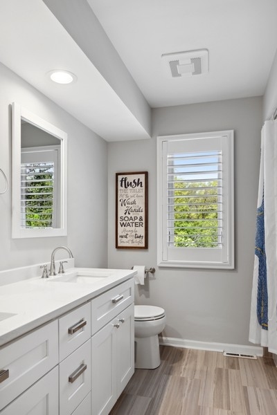 3900 Rugen Road Glenview, IL 60025 - Photo 25 of 44 a bathroom with a toilet sink and window