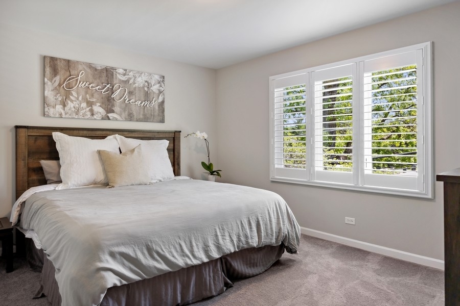 3900 Rugen Road Glenview, IL 60025 - Photo 27 of 44 a bedroom with a bed and a window