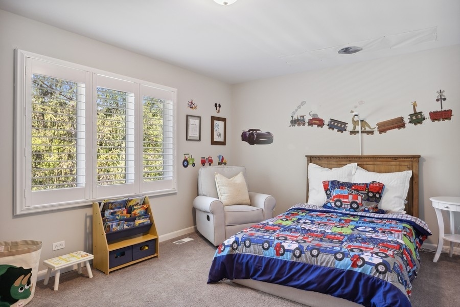 3900 Rugen Road Glenview, IL 60025 - Photo 28 of 44 a bedroom with a bed and a window