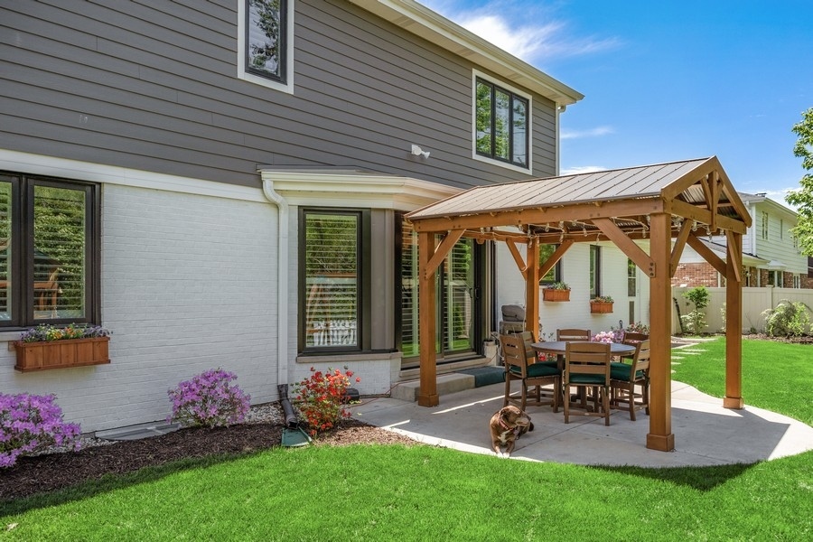 3900 Rugen Road Glenview, IL 60025 - Photo 36 of 44 a view of a house with chair and table in the patio