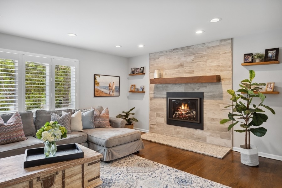 3900 Rugen Road Glenview, IL 60025 - Photo 7 of 44 a living room with furniture a potted plant and a fireplace