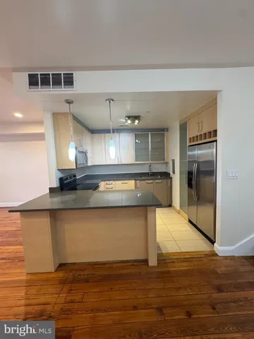 a kitchen with granite countertop a stove and a refrigerator