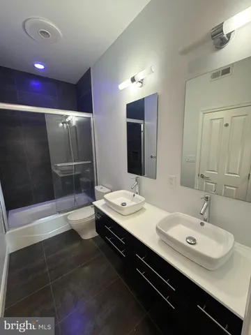 a bathroom with a double vanity sink and mirror