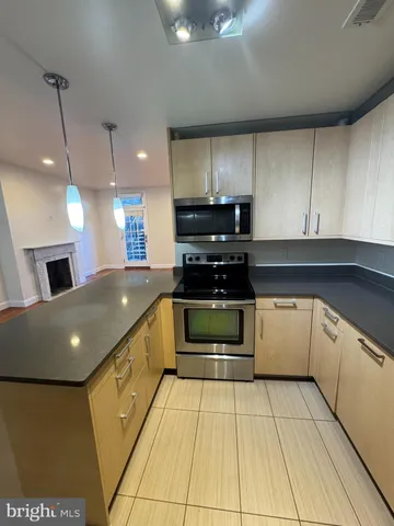 a kitchen with stainless steel appliances kitchen island granite countertop a sink and cabinets