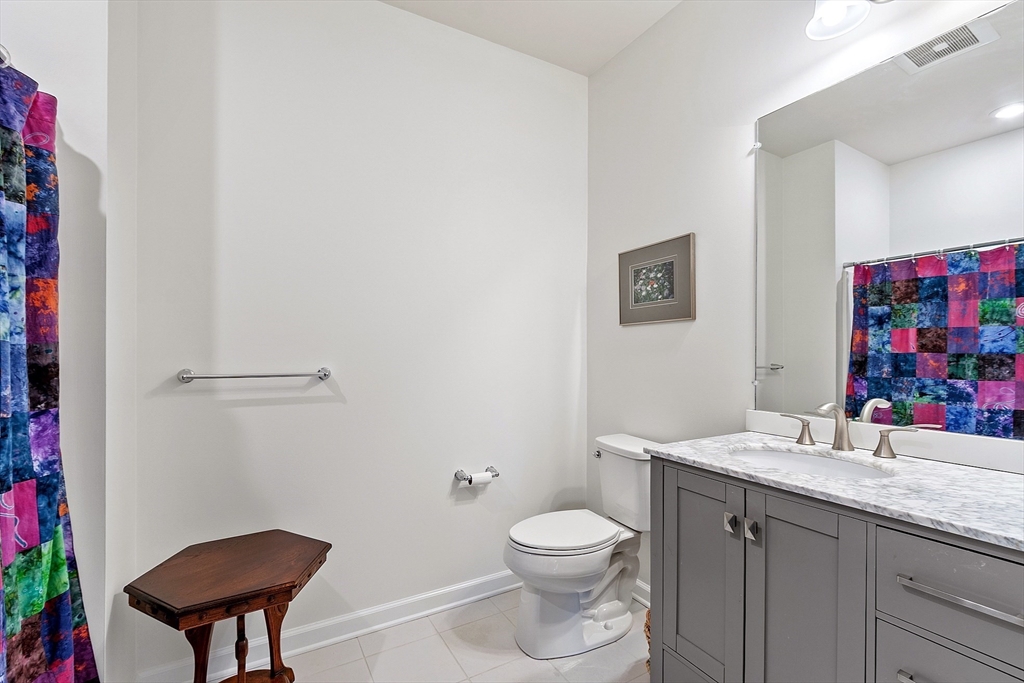62 Abigail Way, Unit 3004 Reading, MA 01867 - Photo 26 of 37 a bathroom with a toilet a sink and a mirror
