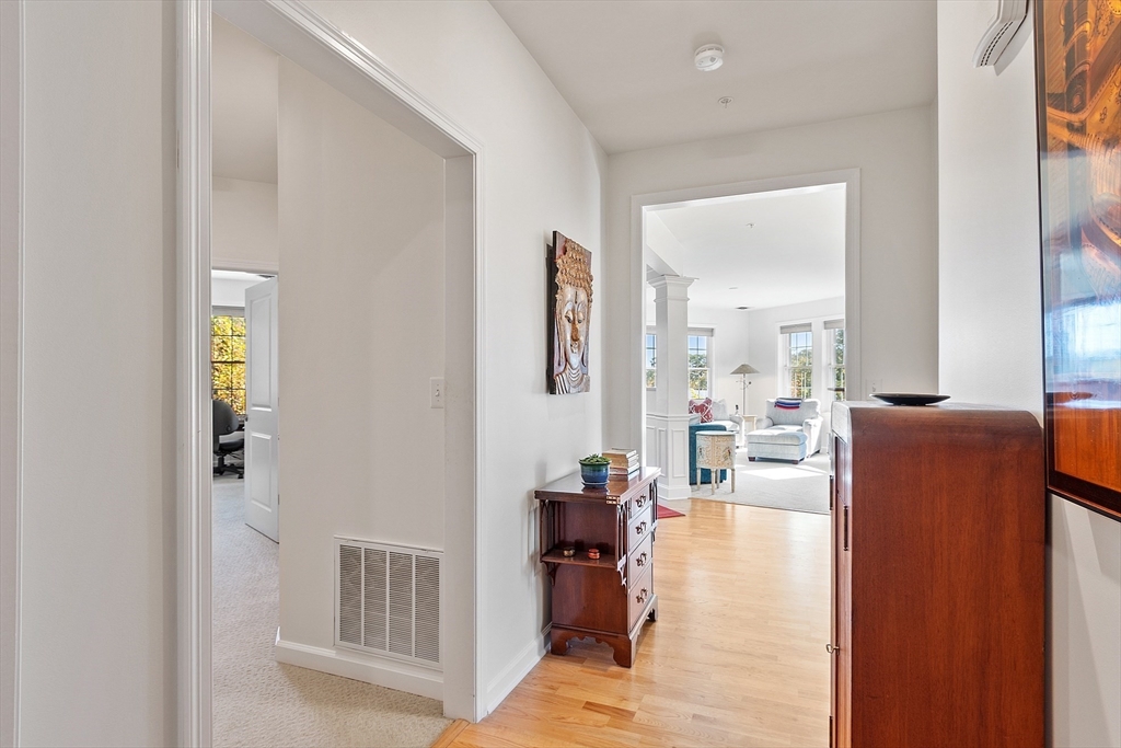 62 Abigail Way, Unit 3004 Reading, MA 01867 - Photo 27 of 37 a living room with furniture and a wooden floor