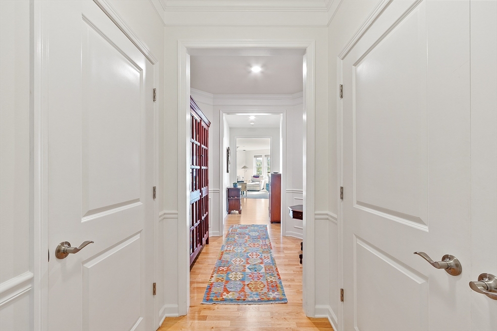 62 Abigail Way, Unit 3004 Reading, MA 01867 - Photo 3 of 37 a view of a hallway with wooden floor and staircase