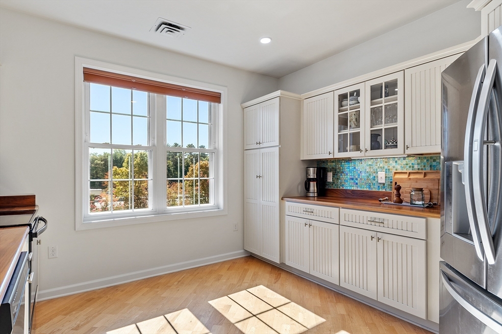 62 Abigail Way, Unit 3004 Reading, MA 01867 - Photo 6 of 37 a kitchen with stainless steel appliances granite countertop a stove a sink and a refrigerator