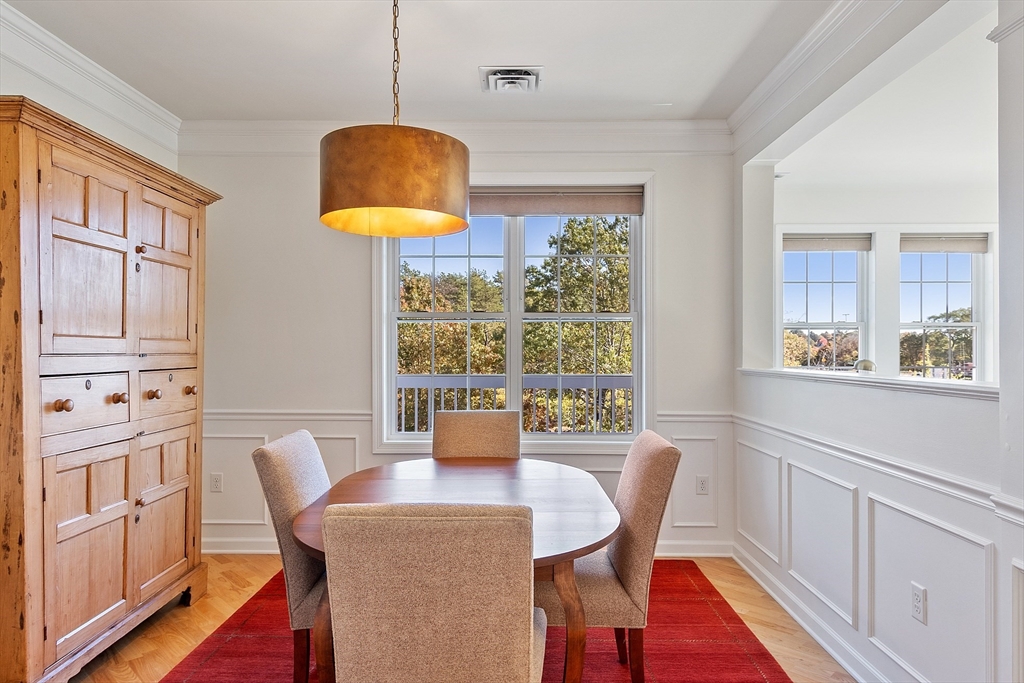 62 Abigail Way, Unit 3004 Reading, MA 01867 - Photo 8 of 37 a dining room with furniture and a window