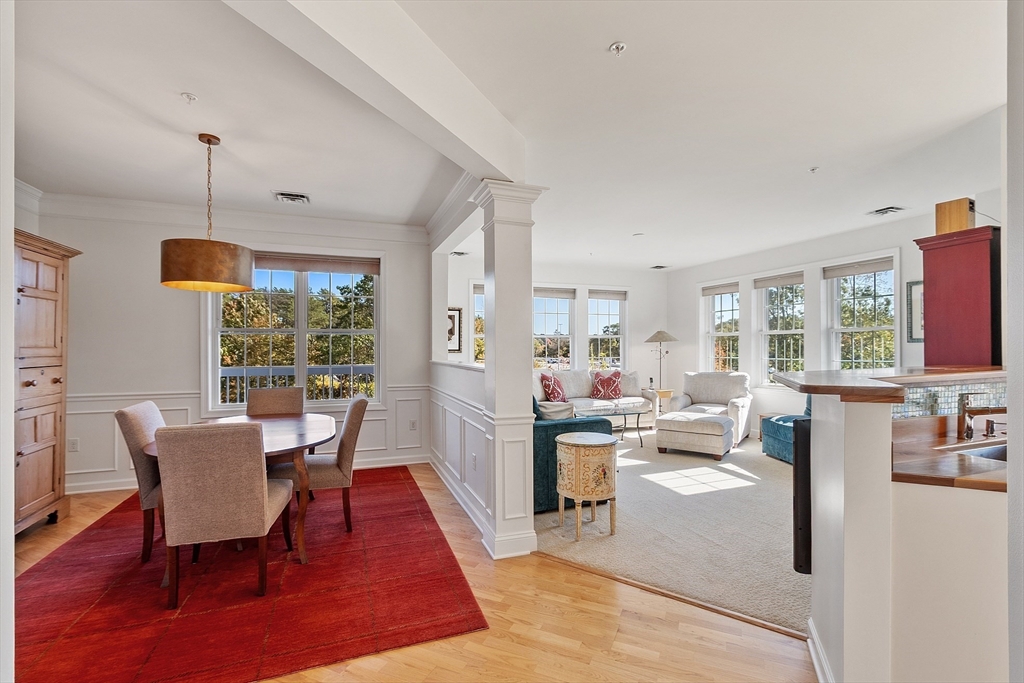 62 Abigail Way, Unit 3004 Reading, MA 01867 - Photo 10 of 37 a living room with furniture a window and a table
