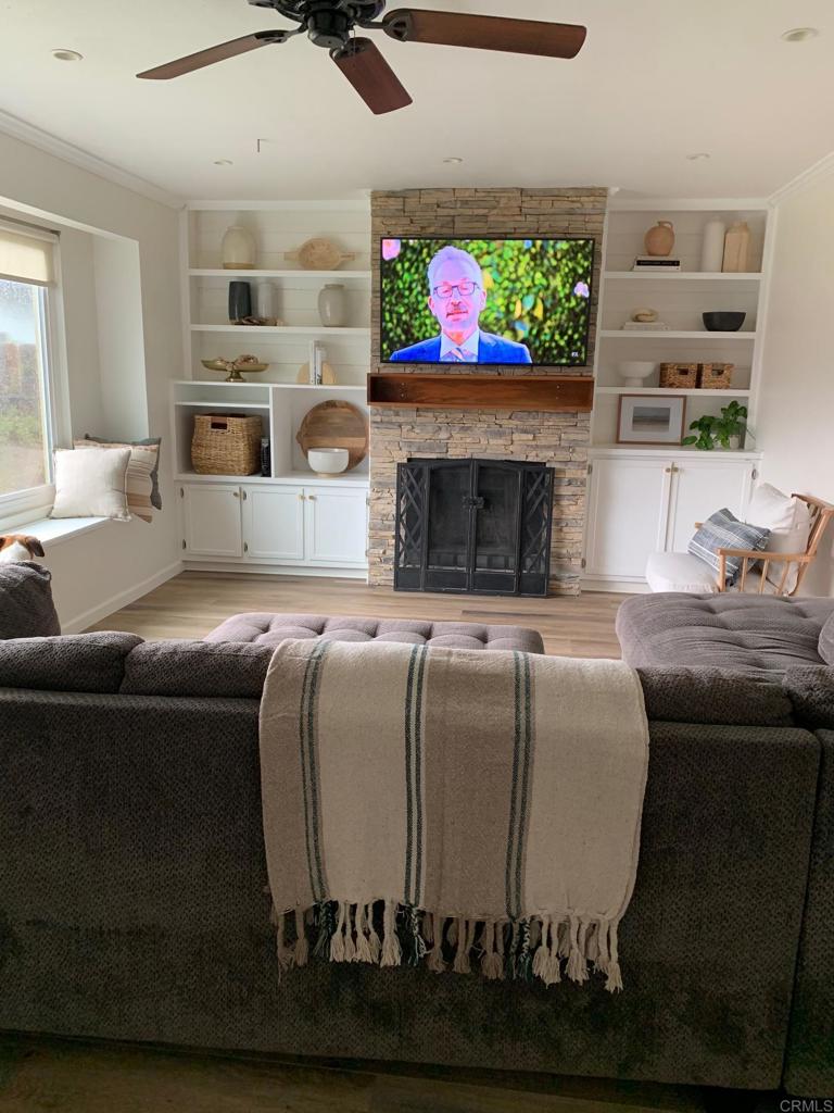 813 Reef Drive San Diego, CA 92154 - Photo 6 of 10 a living room with furniture a fireplace and a flat screen tv