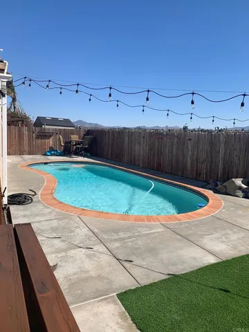 a view of a backyard with wooden fence