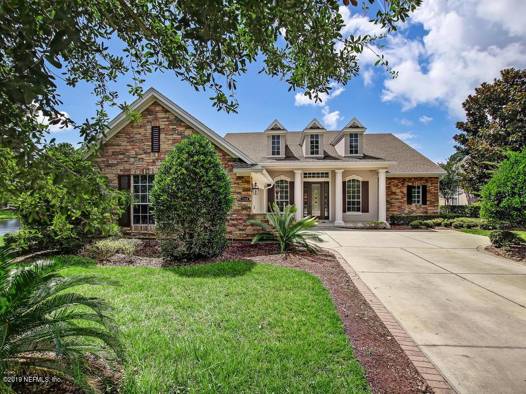 a front view of a house with a yard and porch