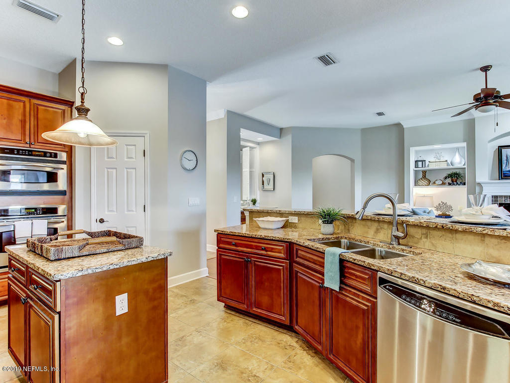 1780 North Loop Parkway St. Augustine, FL 32095 - Photo 21 of 98 a kitchen with stainless steel appliances granite countertop a stove a sink dishwasher and a refrigerator with wooden floor