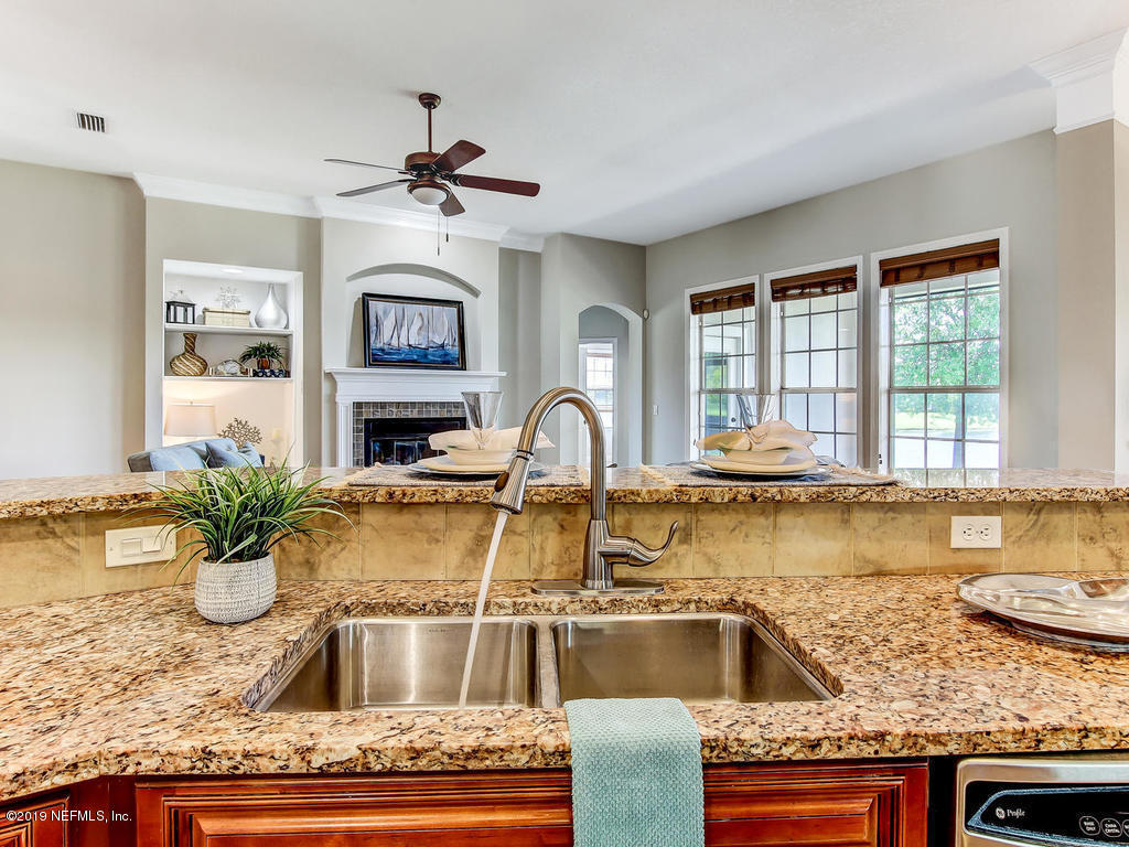 1780 North Loop Parkway St. Augustine, FL 32095 - Photo 24 of 98 a view of a kitchen with granite countertop a sink stainless steel appliances and a counter top space