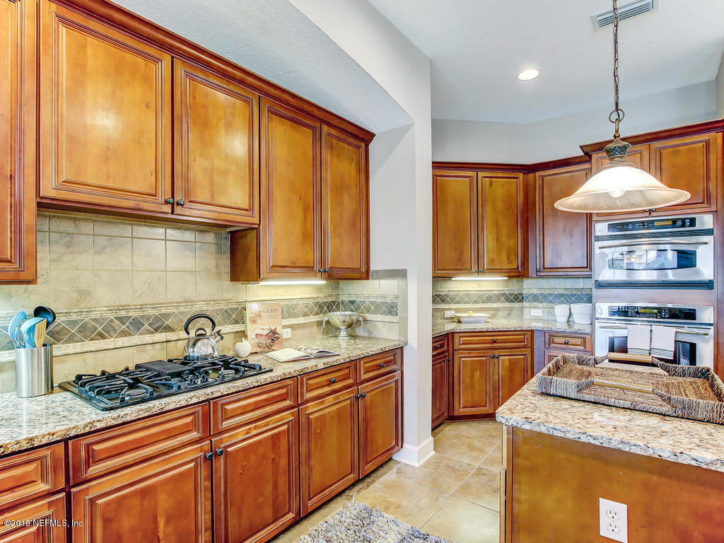 1780 North Loop Parkway St. Augustine, FL 32095 - Photo 3 of 98 a kitchen with stainless steel appliances granite countertop a sink a stove and a wooden cabinets