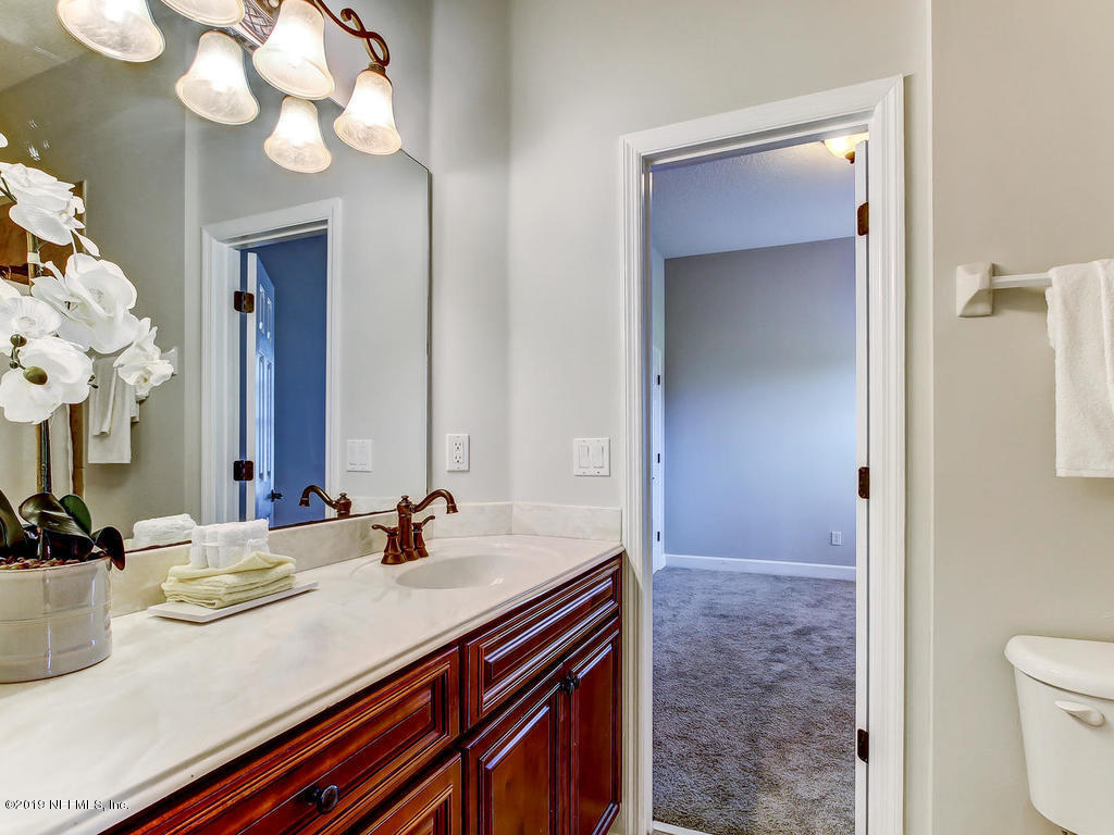 1780 North Loop Parkway St. Augustine, FL 32095 - Photo 38 of 98 a bathroom with a sink vanity and a mirror