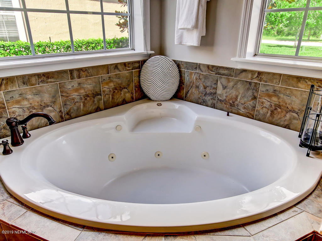 1780 North Loop Parkway St. Augustine, FL 32095 - Photo 39 of 98 a white bath tub sitting in a bathroom next to a window