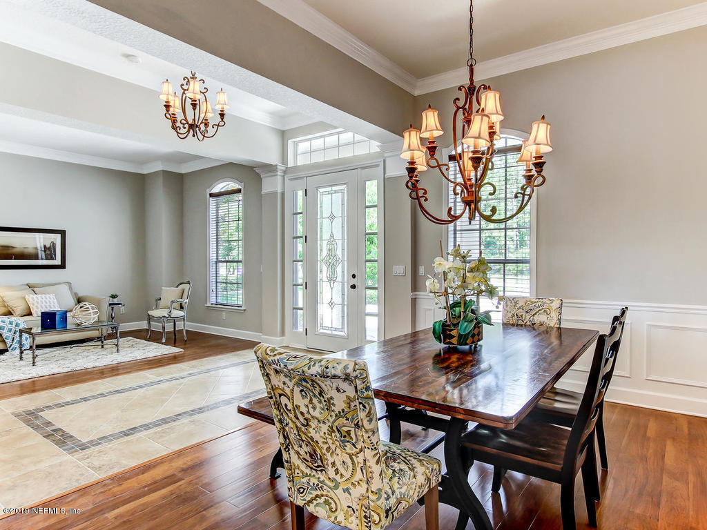 1780 North Loop Parkway St. Augustine, FL 32095 - Photo 4 of 98 a view of a dining room with furniture a chandelier and wooden floor