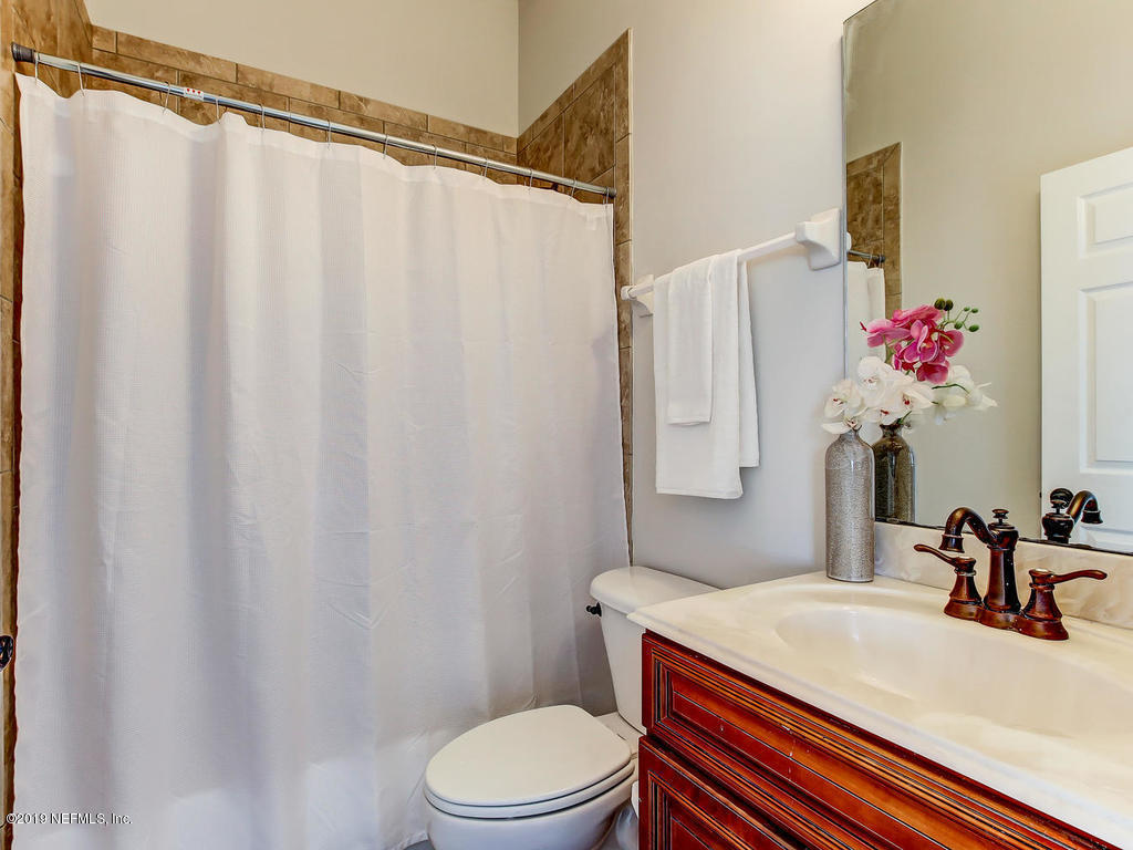 1780 North Loop Parkway St. Augustine, FL 32095 - Photo 47 of 98 a bathroom with a sink vanity mirror and toilet