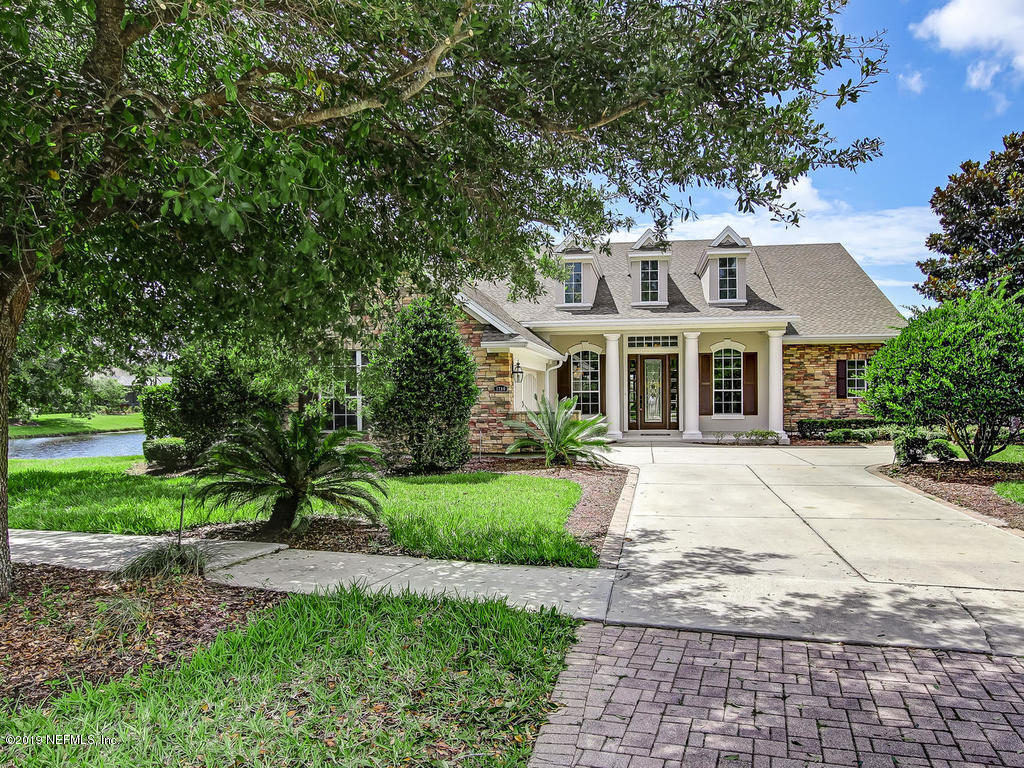 1780 North Loop Parkway St. Augustine, FL 32095 - Photo 65 of 98 a front view of a house with a yard and potted plants