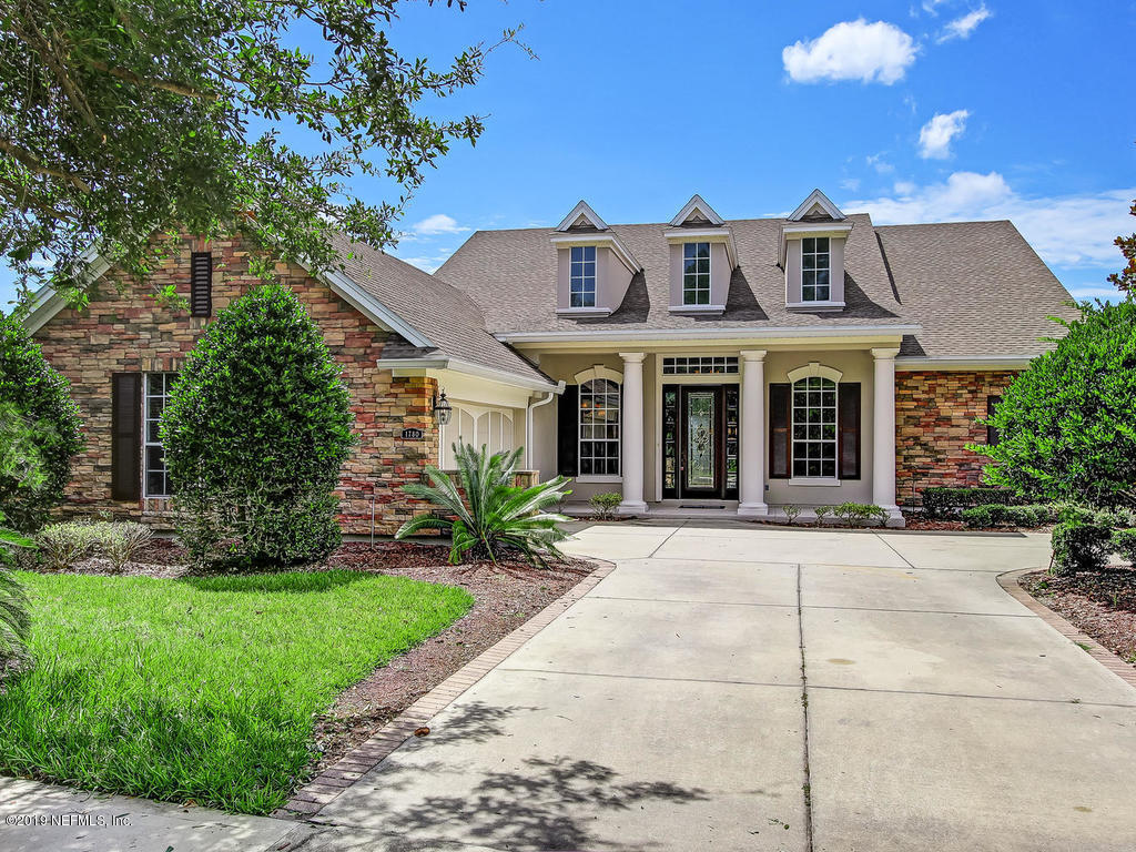 1780 North Loop Parkway St. Augustine, FL 32095 - Photo 9 of 98 a front view of a house with a garden and plants