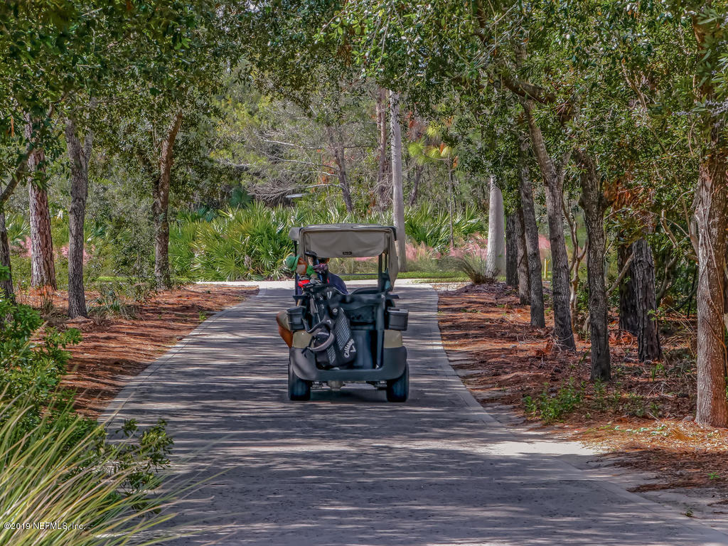 1780 North Loop Parkway St. Augustine, FL 32095 - Photo 92 of 98 a view of a patio with table and chairs with wooden floor and fence