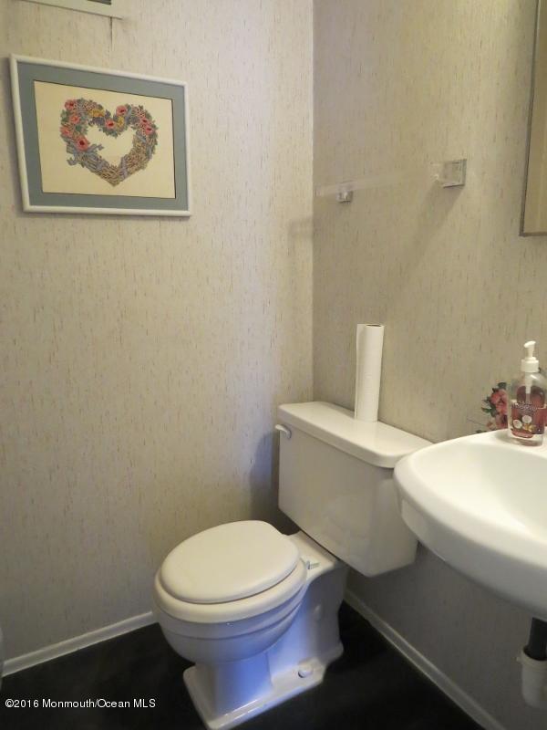 200 Bethany Road Hazlet, NJ 07730 - Photo 18 of 22 a white toilet sitting next to a bathroom sink