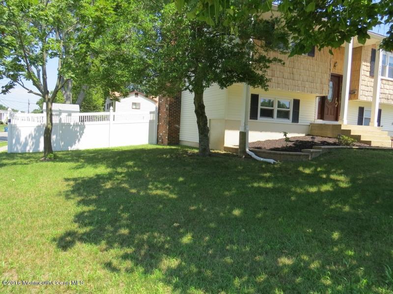 200 Bethany Road Hazlet, NJ 07730 - Photo 3 of 22 a view of a white house with a big yard and large trees